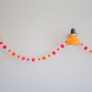 pom pom festival garland with orange and pink pom poms