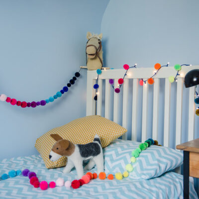 Rainbow Pom Pom Garland in bedroom