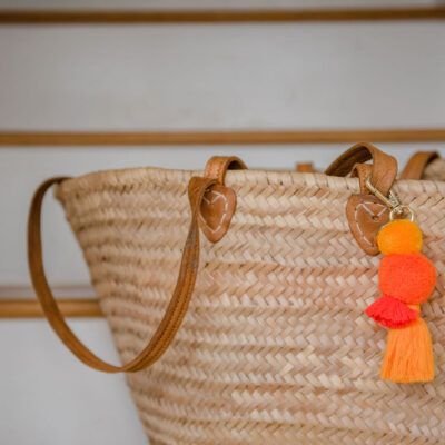 Sunshine pom pom and tassel key ring and bag charm on basket