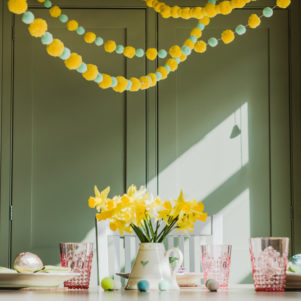 Yellow Pom Pom garland with mint and yellow garland above table